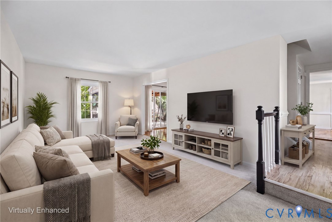 Neutral wall color palette, carpeted flooring, and a wooden stair railing with white balusters Neutral wall color palette, carpeted flooring, and a wooden stair railing with white balusters