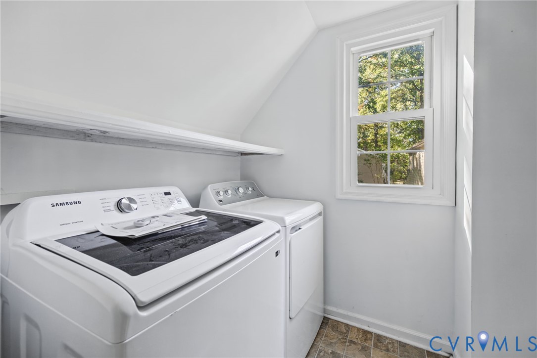 Laundry area featuring a built-in shelf, multi-pane window, and resilient flooring