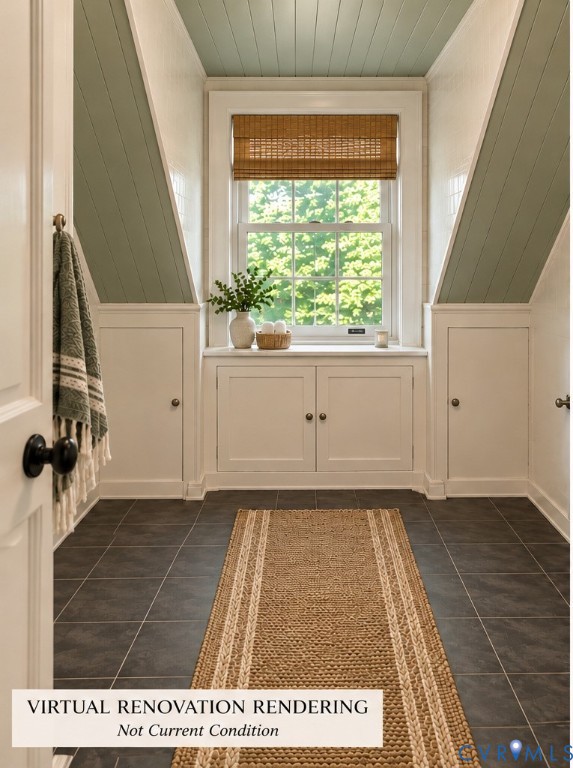 Dormer window with integrated storage cabinetry, finished with painted tongue-and-groove paneling and dark tile flooring