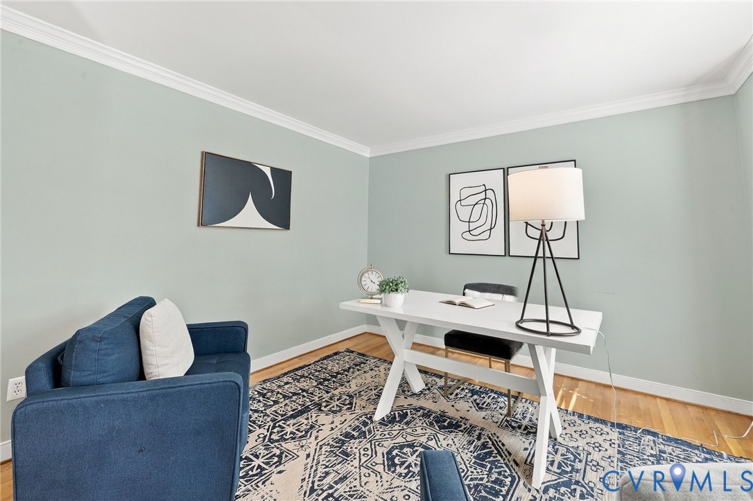 Versatile first-floor office featuring hardwood floors, crown molding, and plenty of room for a dedicated workspace.
