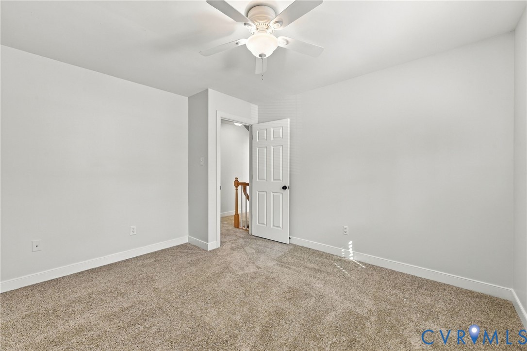 Bedroom number 2 featuring neutral paint, plush new carpeting, ceiling fan, and ample closet space.
