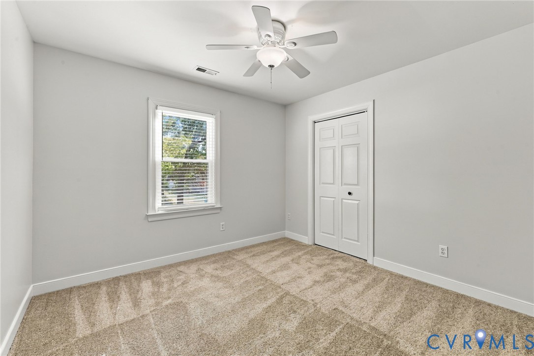 Another view of the spacious and bright secondary bedroom.