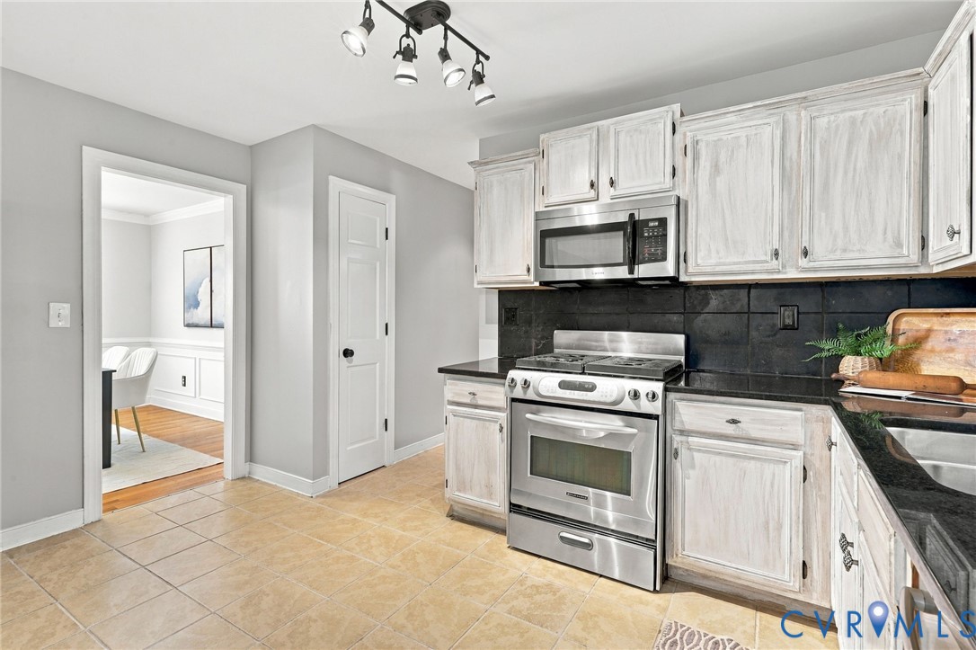 Door next to dining room is the pantry, then down the hallway leads to a half bath and door leading to garage.