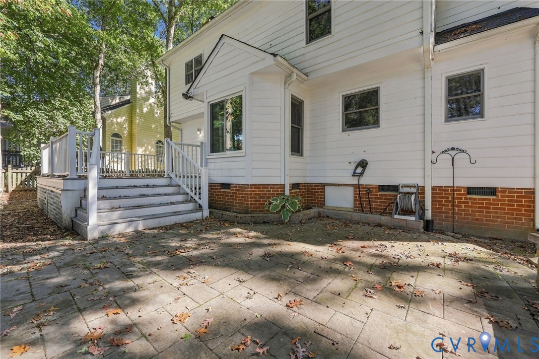 Spacious paver patio with easy access to the elevated deck, offering additional space for outdoor dining, entertaining, and relaxing.