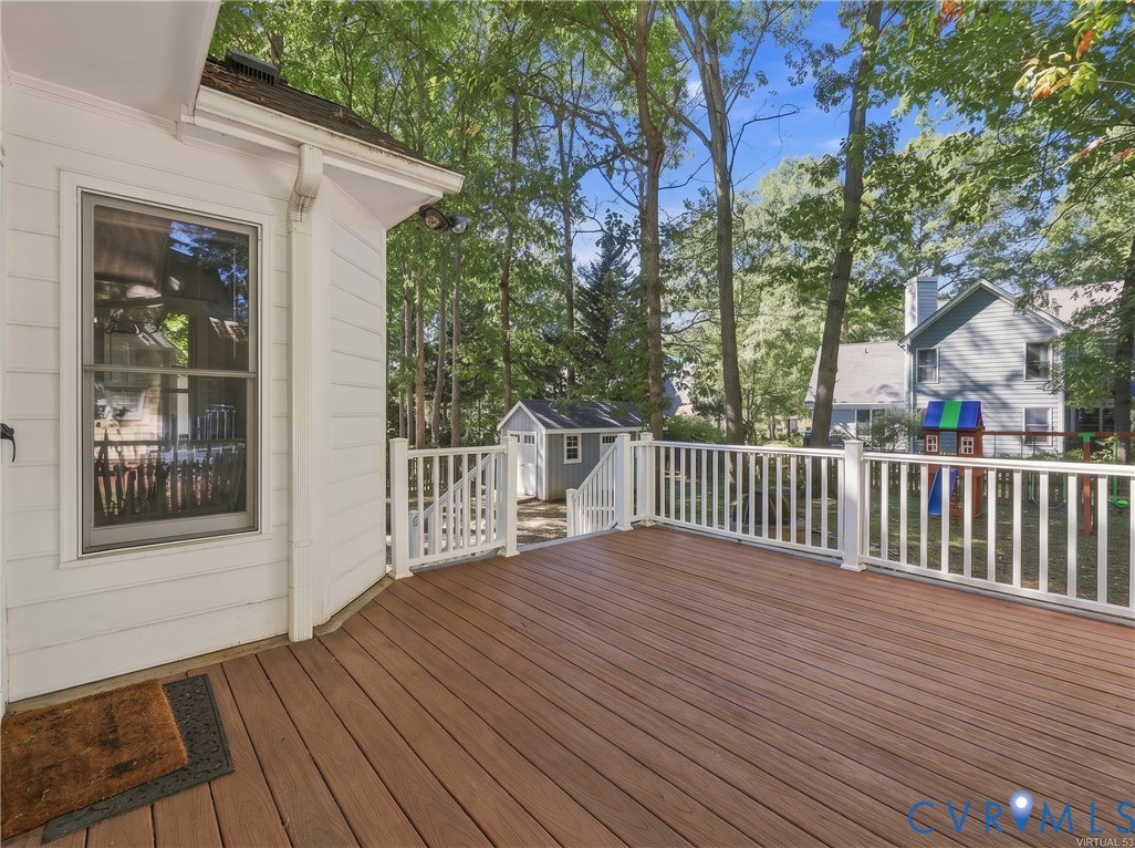 Spacious rear low maintenance composite deck with convenient access to the backyard and stone patio.