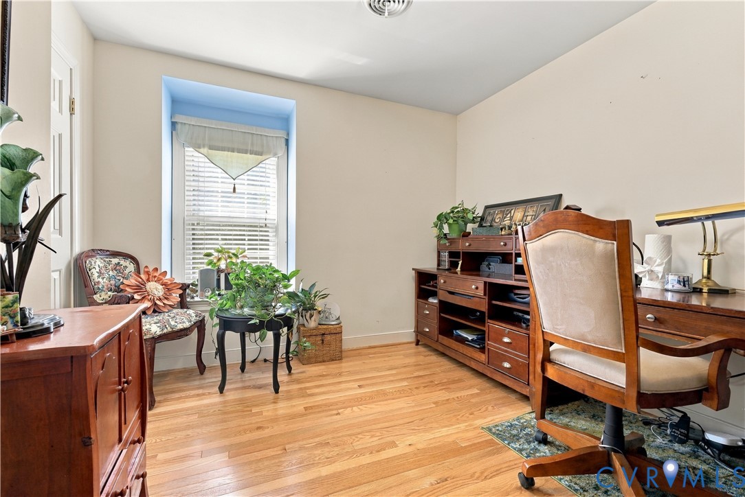 Wood-finish flooring, recessed window bay, and crisp neutral wall paint