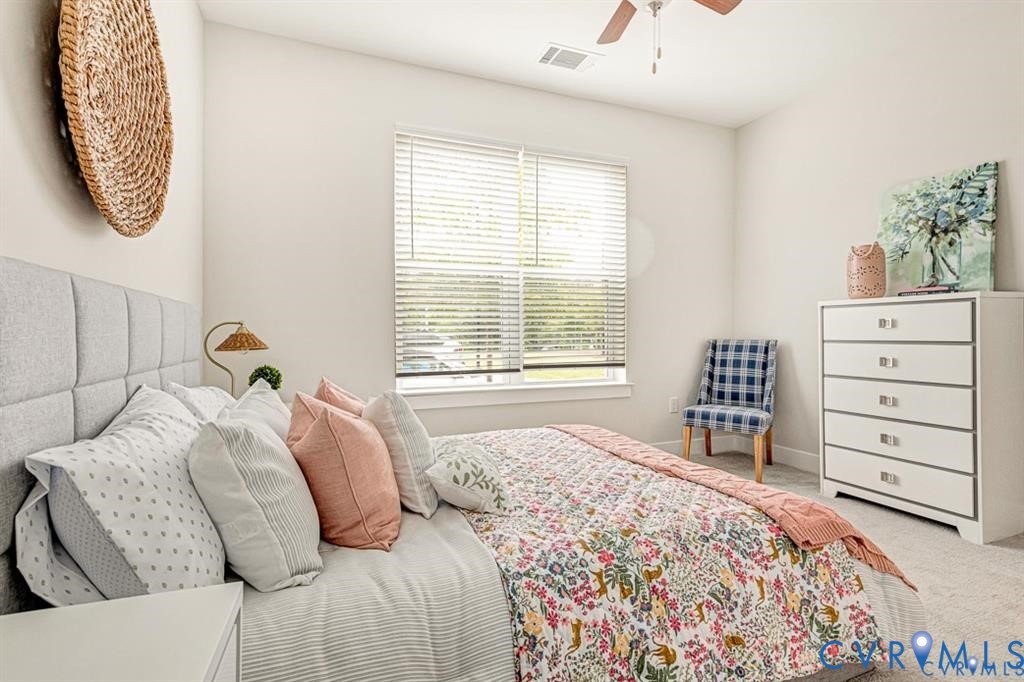 Neutral interior space featuring high-pile carpeting, neutral wall color, large window with horizontal blinds, and a ceiling-mounted fan