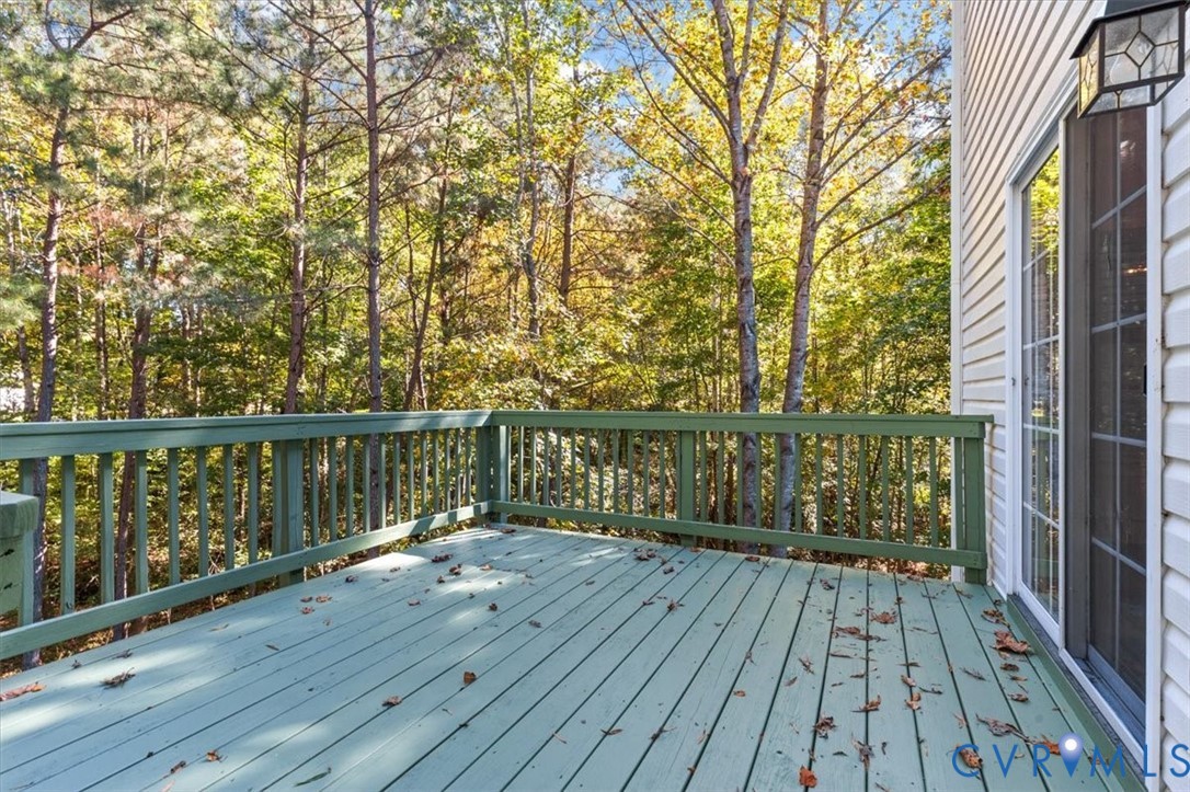 Elevated wooden deck nestled among the trees perfect for entertaining.  Sliding doors to the deck are off the dining area