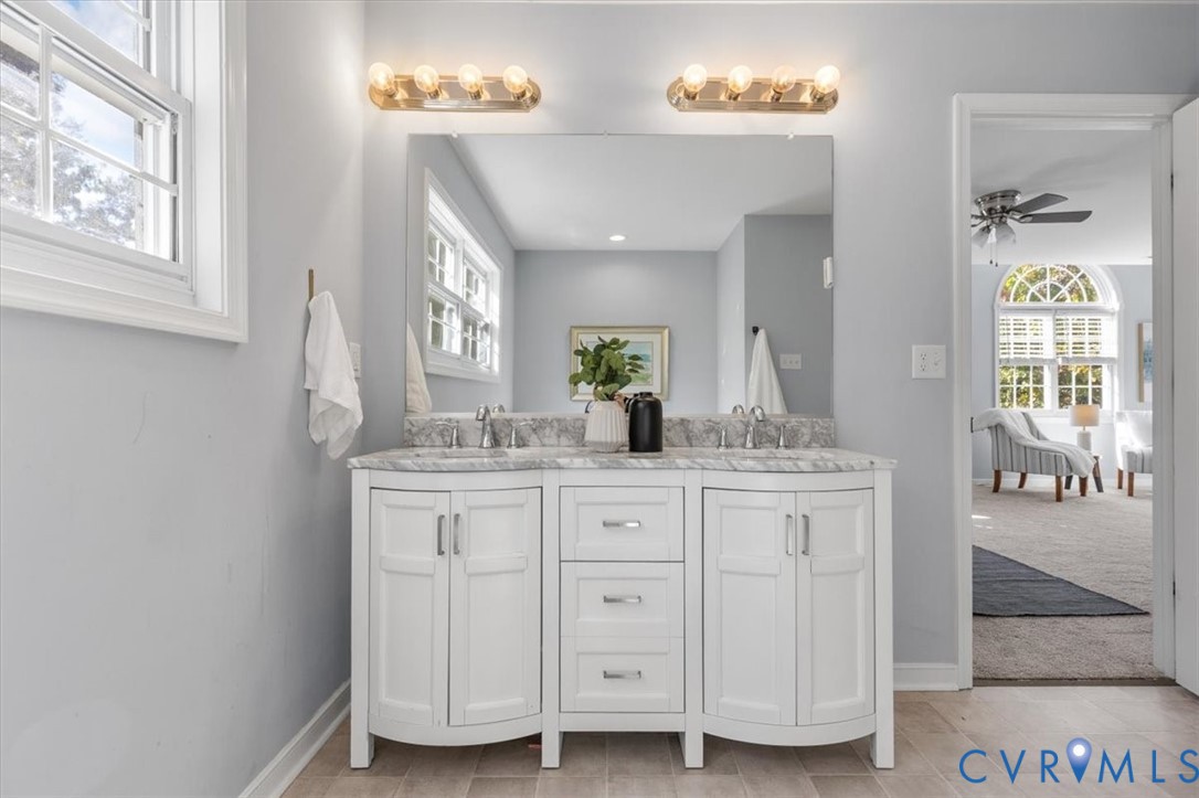 Primary Ensuite with dual-sink vanity with stone countertop, jetted soaking tub and shower.