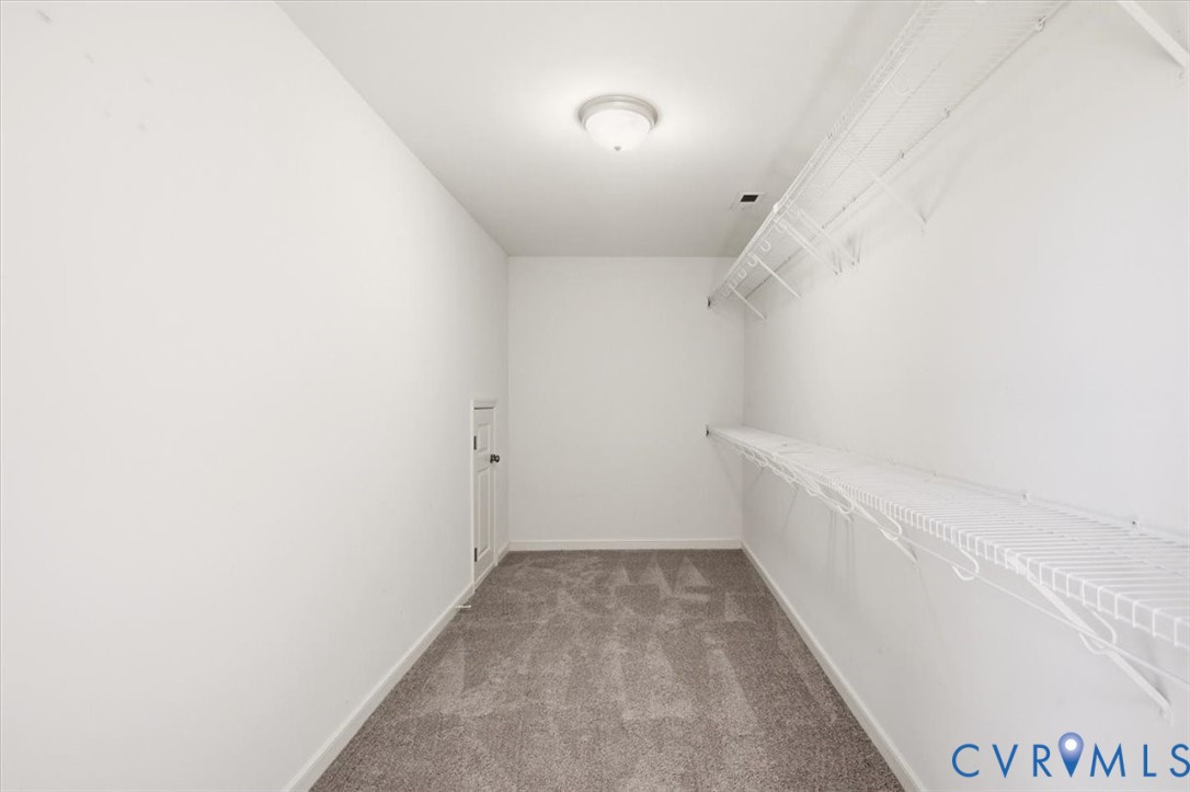 Huge walk in primary bedroom closet