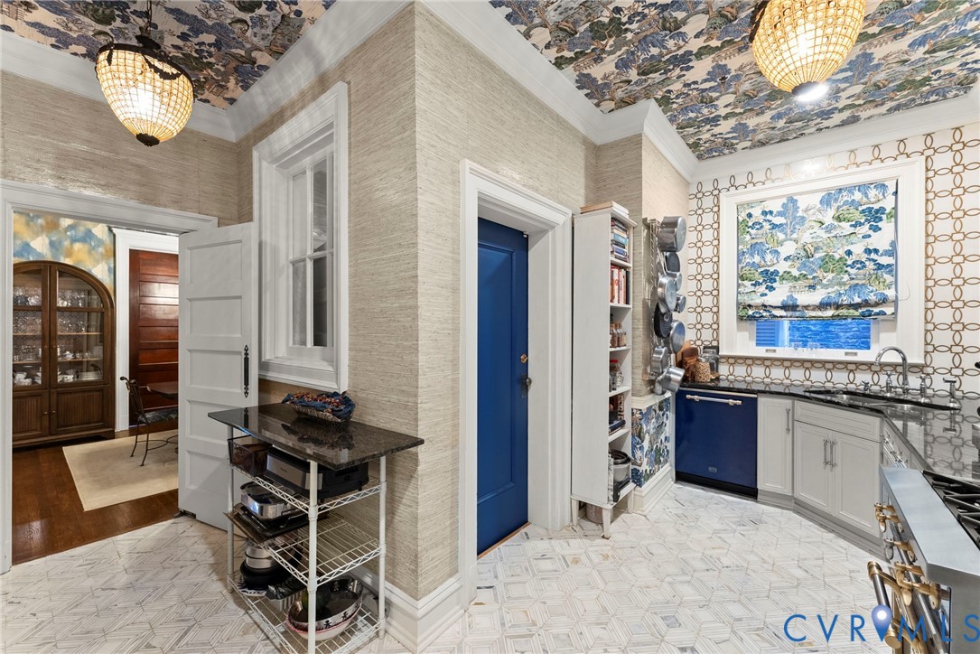 Textured wall coverings, patterned ceiling detailing, built-in shelving, geometric tile flooring, and decorative hanging light fixtures