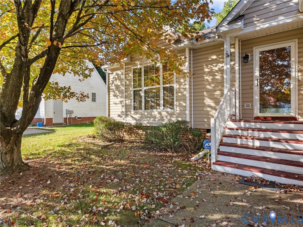 Exterior featuring horizontal siding, a multi-pane window, and an entry staircase with white railings