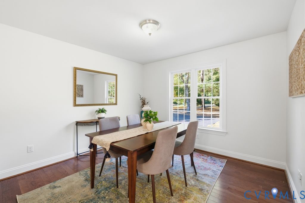 Interior space featuring wood-finish flooring, double-pane grid windows, and a flush-mount light fixture
