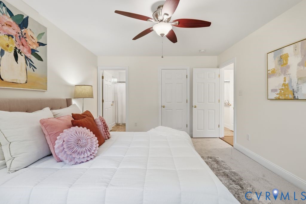 Neutral wall paint, ceiling fan with light kit, carpeted flooring, and six-panel interior doors