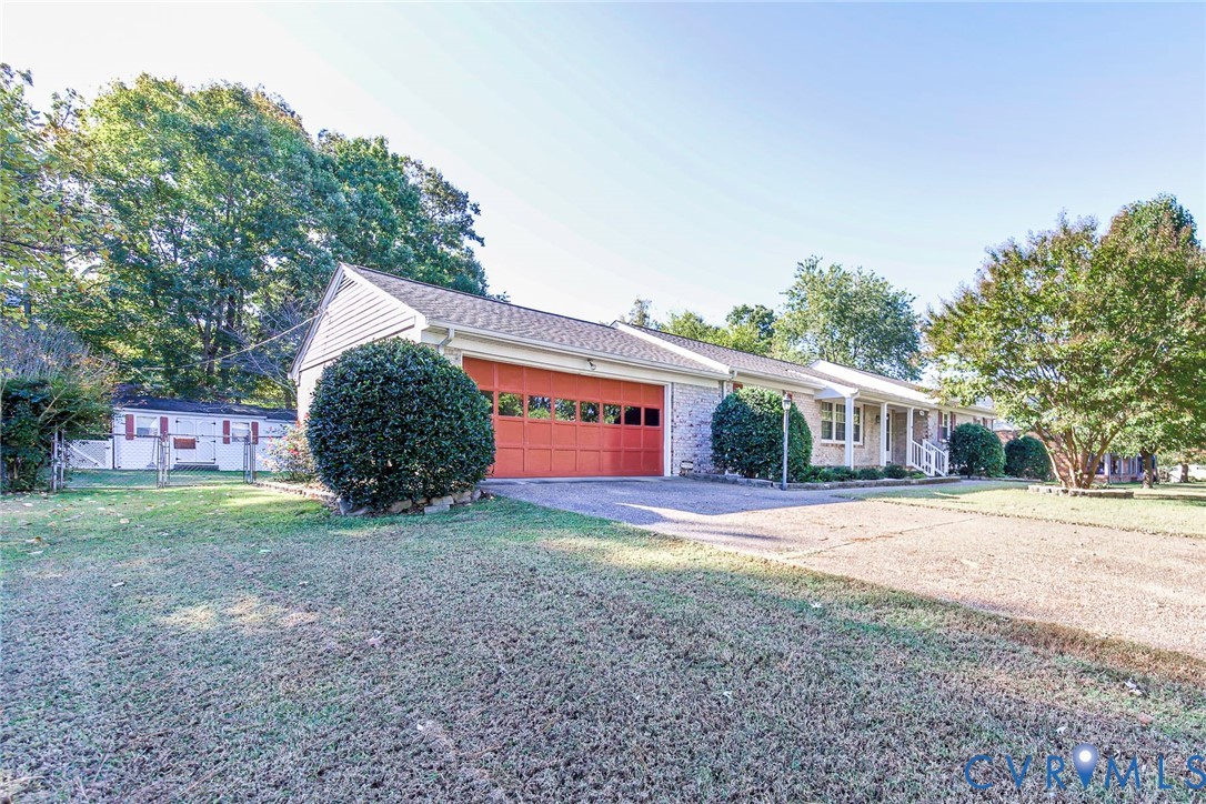 Single-story exterior featuring a brick and siding facade, an attached two-car garage with carriage-style doors, a concrete driveway, and covered front entry Single-story exterior featuring a brick and siding facade, an attached two-car garage with carriage-style doors, a concrete driveway, and covered front entry