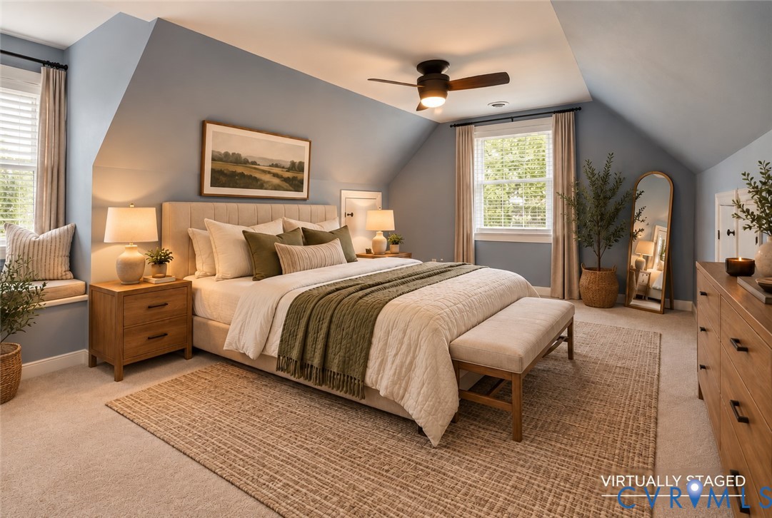 Bedroom featuring vaulted ceilings, dormer window with integrated bench seating, and a ceiling-mounted light fixture