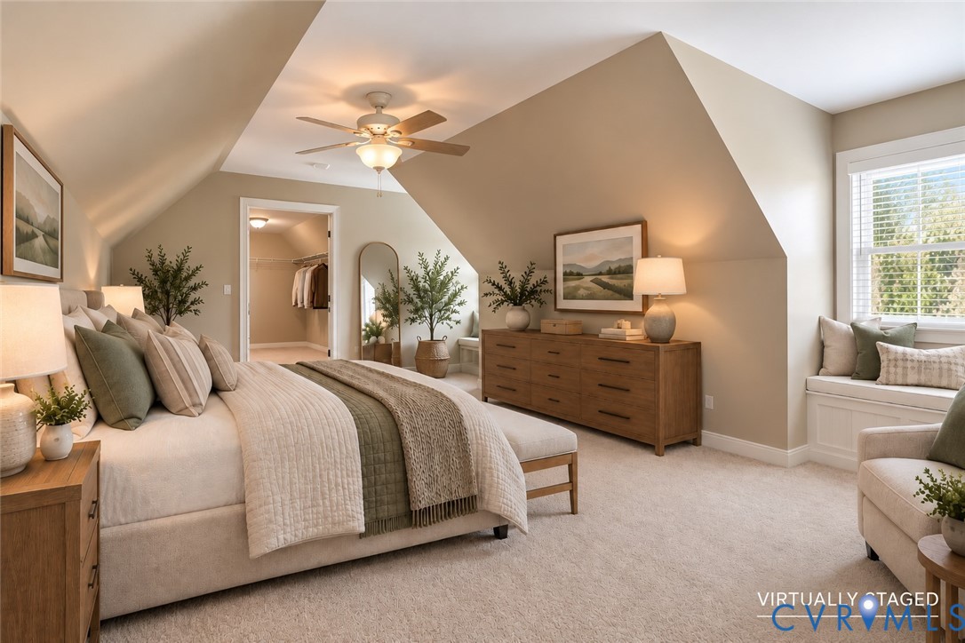 Vaulted ceilings with architectural roof lines, integrated window seat, carpeted flooring, and ceiling fan with light fixture