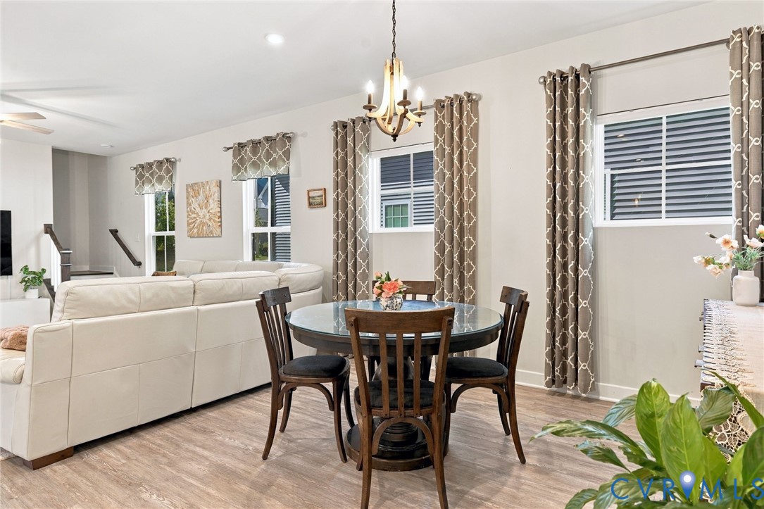 Open concept interior featuring wood-finish flooring, recessed lighting, and a multi-light chandelier