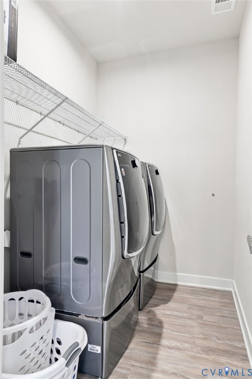 Laundry area featuring wood-finish flooring and wire shelving