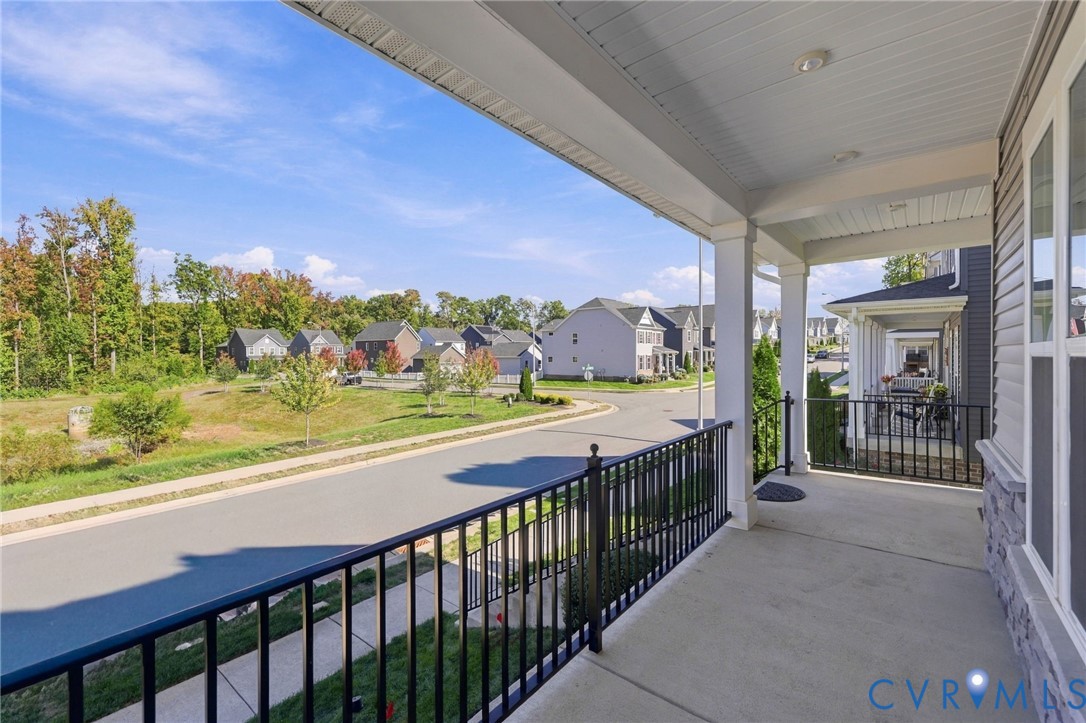 Covered front porch featuring a concrete floor, beadboard ceiling, recessed lighting, and black metal railings