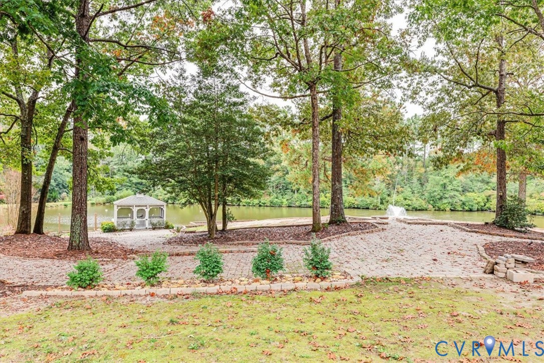 Beautiful view of the extensive hardscaping and landscaping, fountain in the pond and gazebo