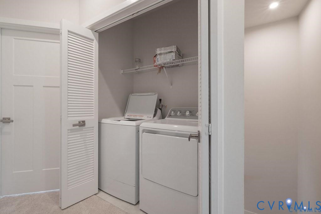 Laundry closet featuring white louvered doors, wire shelving, and recessed ceiling lighting