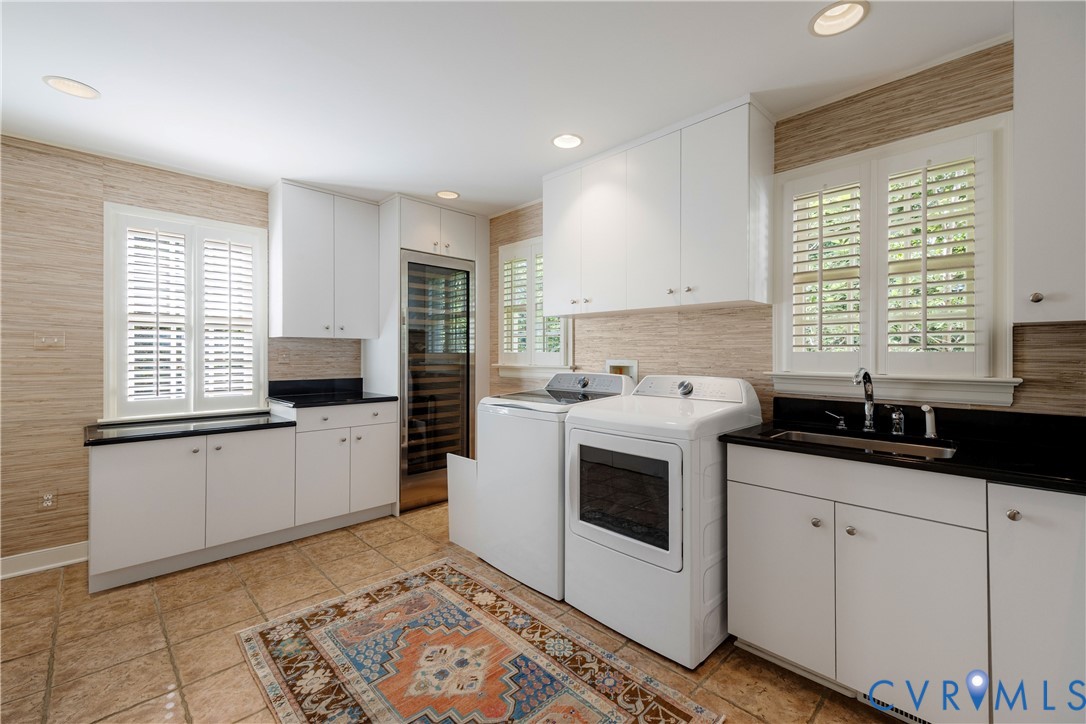 This multi-use butler's pantry has a tile floor, plantation shutters and lots of cabinets and counterspace for projects and storage!  Great place for the full-sized Sub-Zero wine fridge!