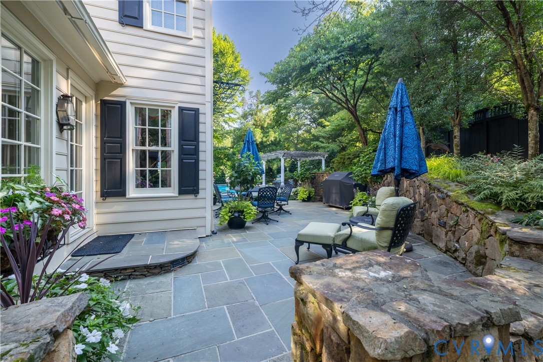Just outside the breakfast toom is the flagstone terrace with stacked stone retaiing walls and passageway to the pool.