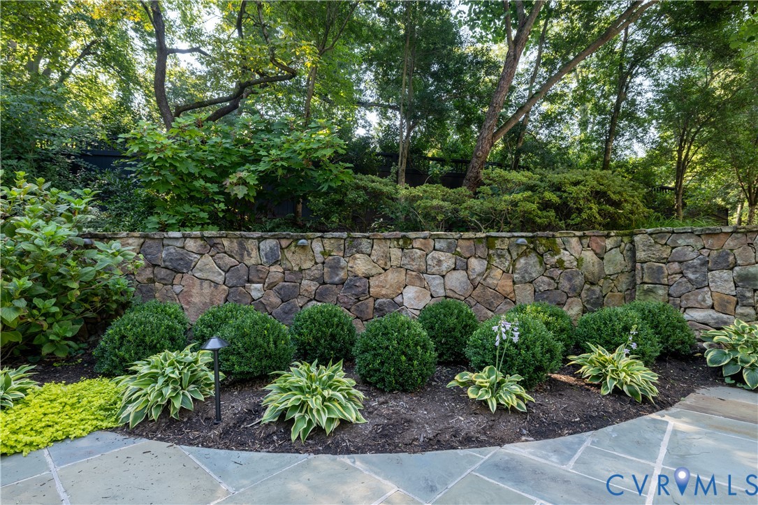 Manicured boxwood and mature tree canopy