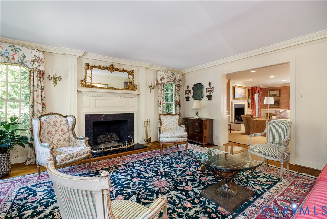 The living room showcases the home's extraordinary mouldings and multitude of windows to enjoy the year round views.