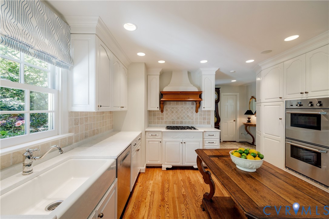 Wall of built-in cabinets to the right continues into the back hallway.