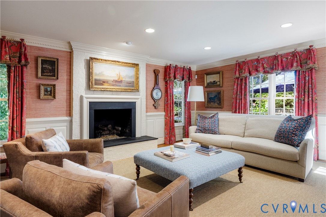 Handsome wall coverings, mouldings and the painted brick fireplace add to the appeal of this special gathering space.