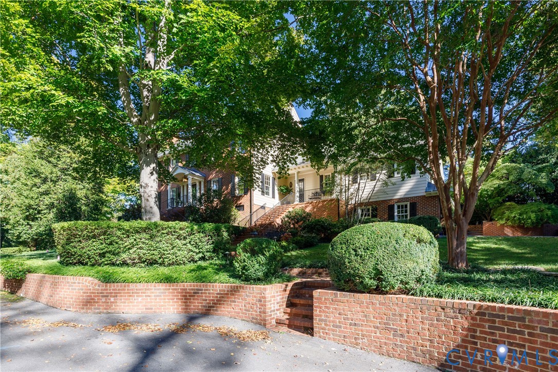 Distinctive low brick retaining wall surrounds the property and adds to the appeal of this colonial home.