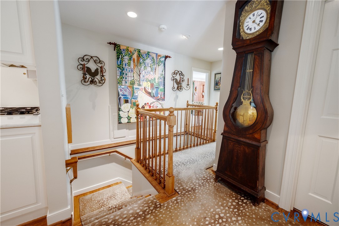 The second front entrance opens to the rear hallway with stairs to the garage and access to the study and butler's pantry/laundry center.