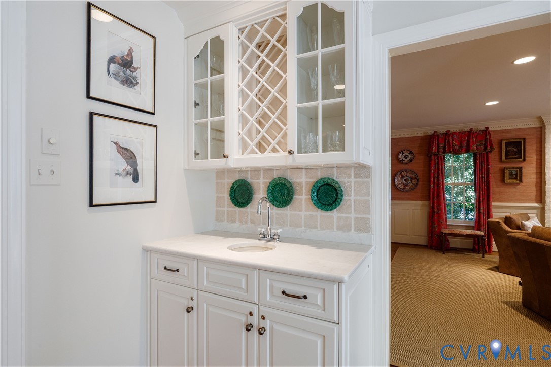 Built-in bar features a bar sink and lots of glassware storage.