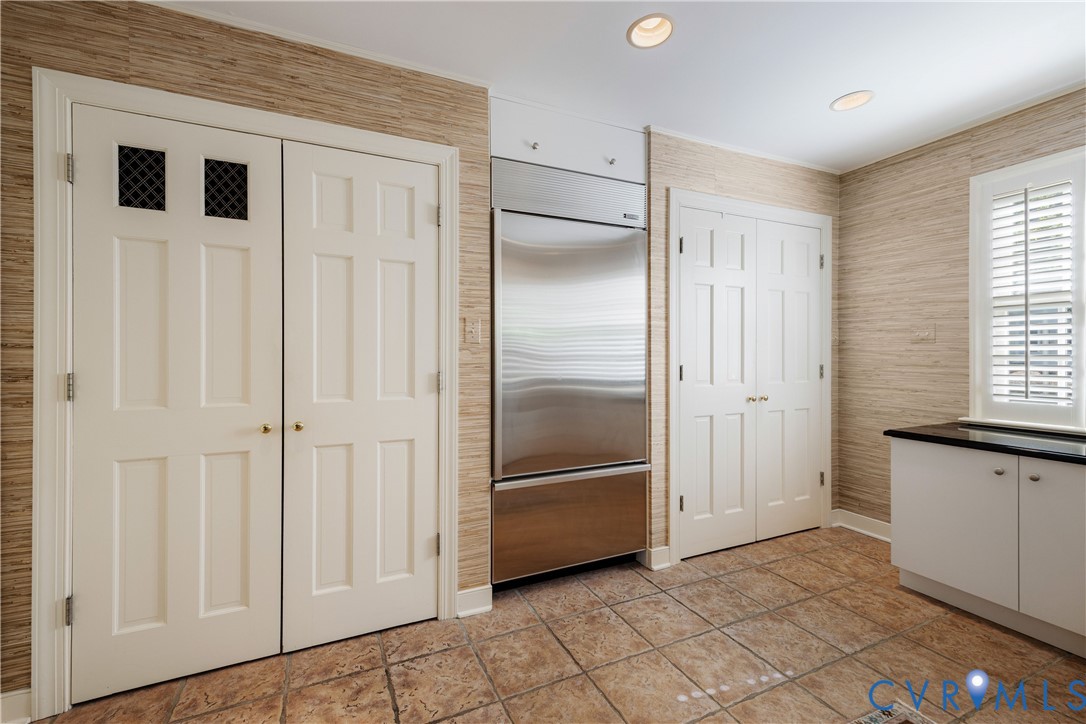 This wall of closets includes space for a second full-size Sub-Zero refrigerator and freezer.