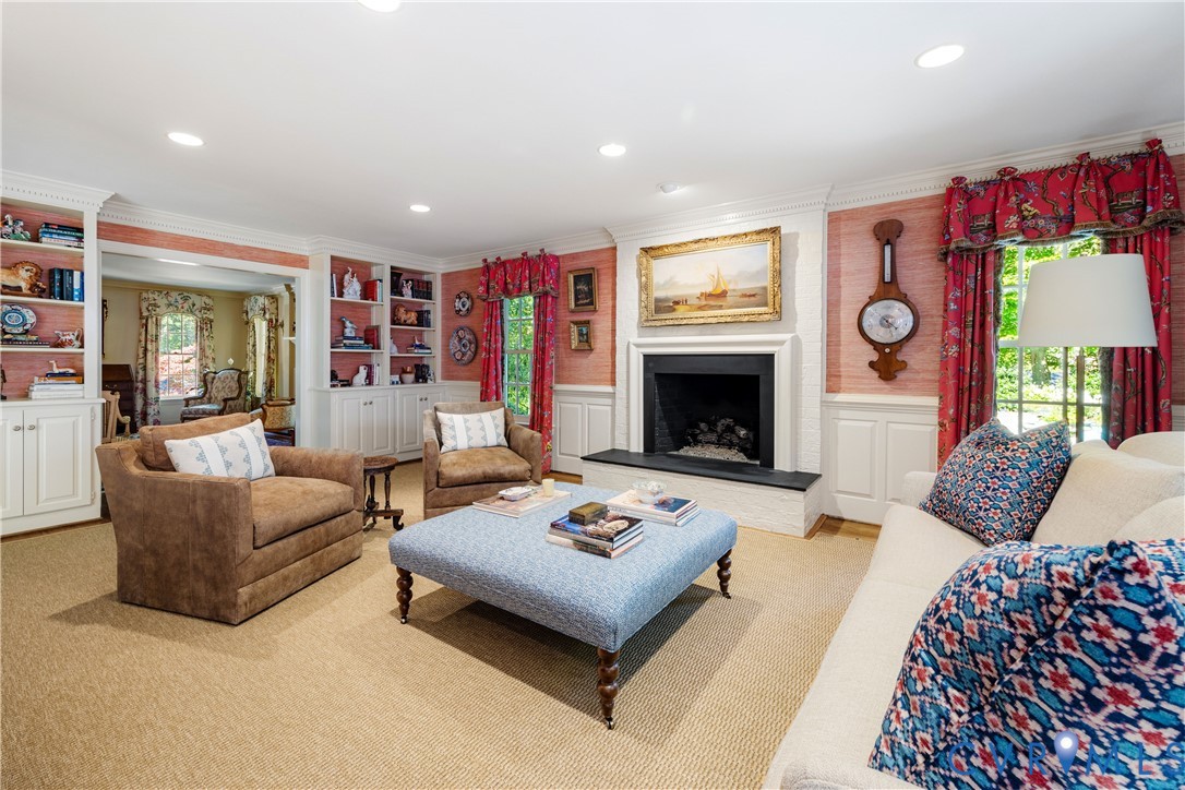 Built-in display shelves with cabinets below flank the entry to the living room.
