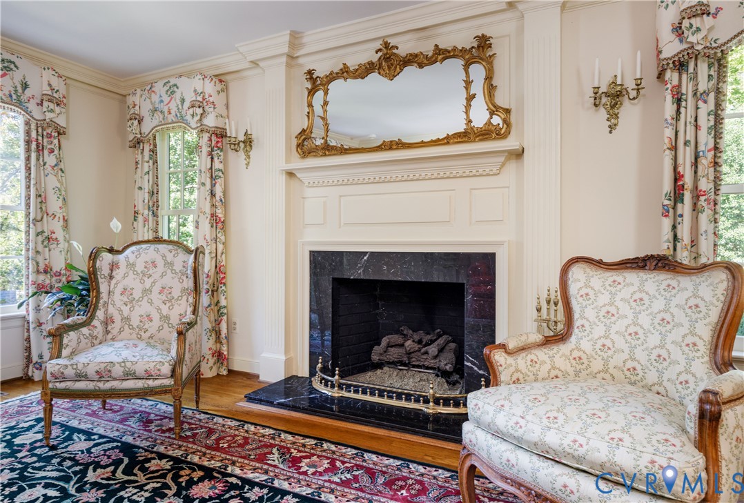 Fireplace featuring a marble surround and hearth and handsome chimney breast flanked by fluted columns.