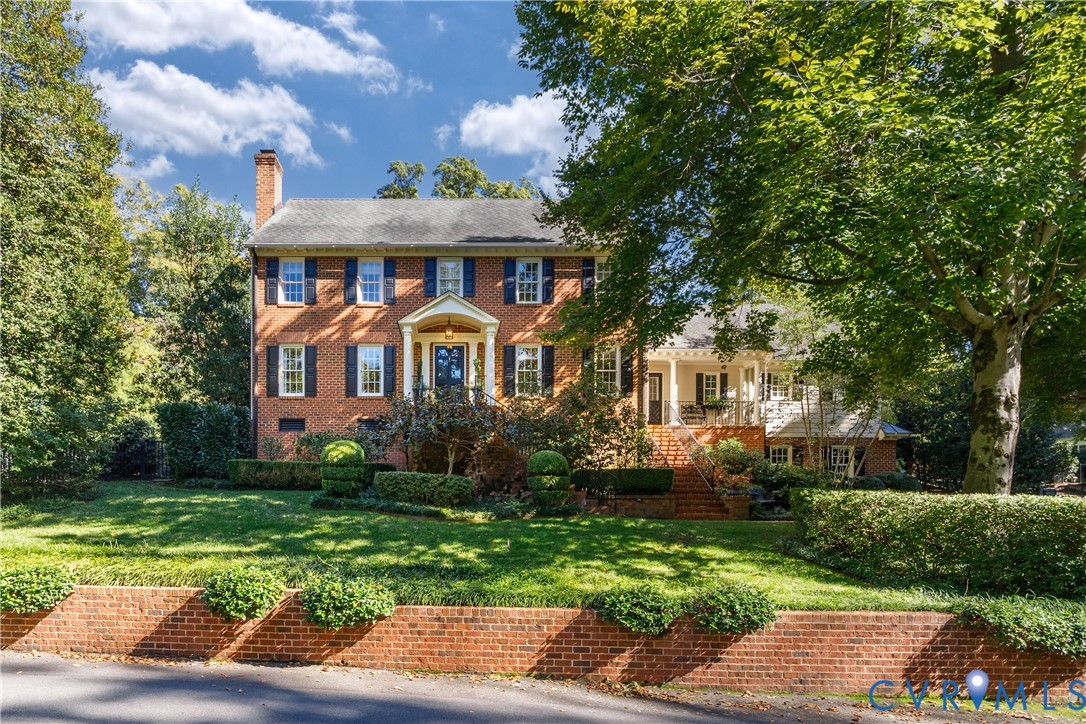 Welcome to this handsome brick colonial featuring a side entry covered porch.