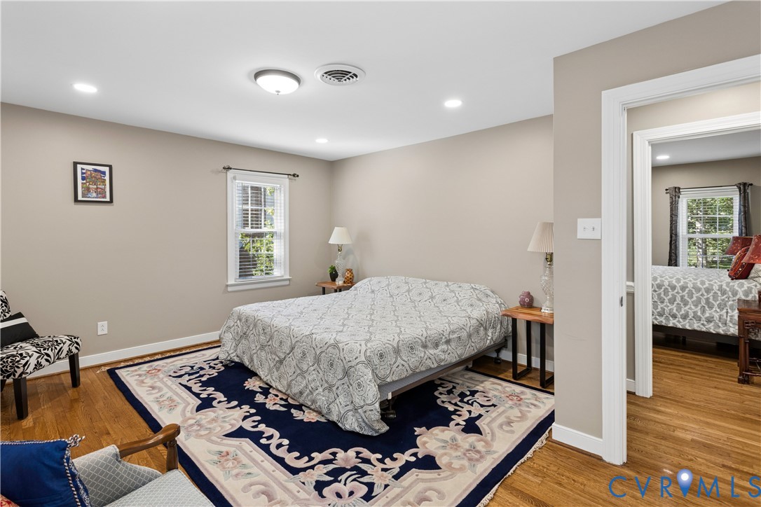Neutral wall paint, wood-finish flooring, recessed lighting, and multi-pane windows