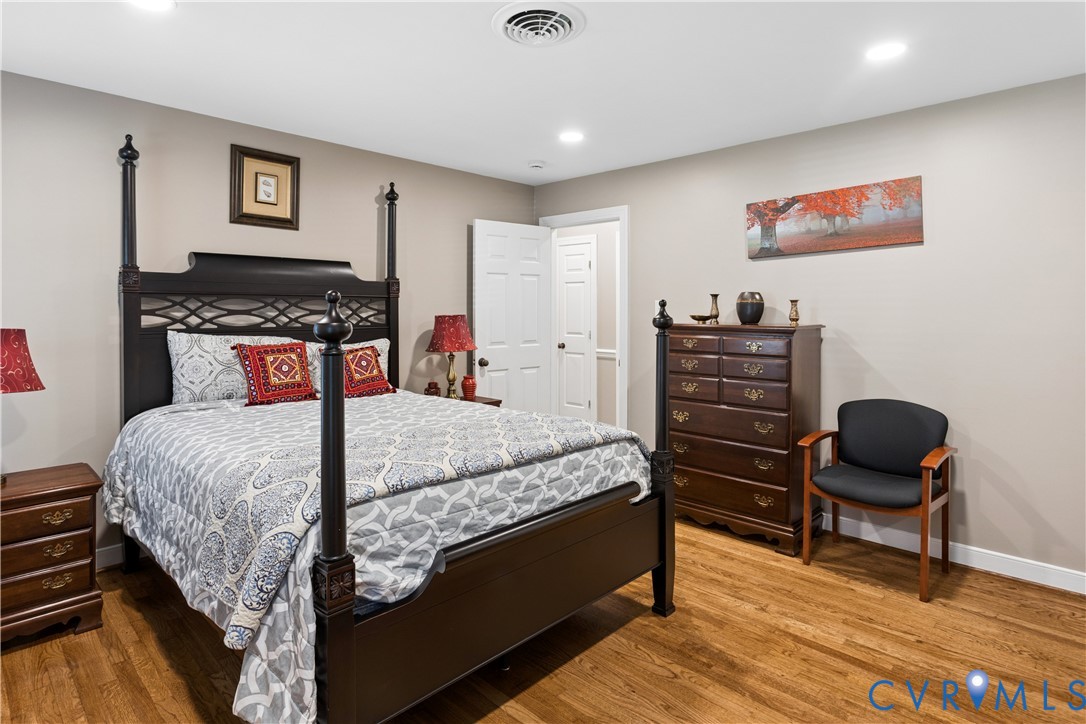 Interior space featuring wood-finish flooring, neutral wall paint, and recessed lighting