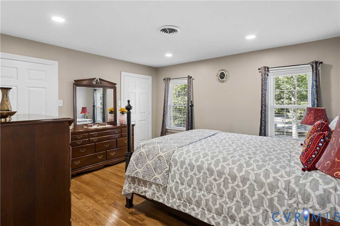Interior space featuring wood-finish flooring, recessed lighting, and dual windows with multi-pane glass