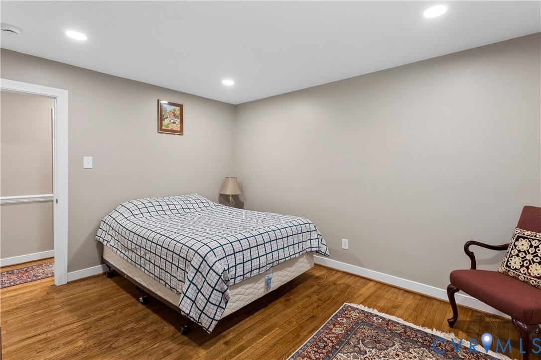 Neutral-toned interior space featuring wood-finish flooring and recessed lighting
