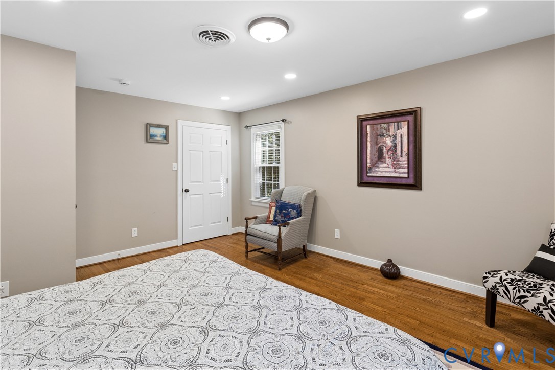 Interior space featuring wood-finish flooring, recessed lighting, and a multi-pane window with interior trim