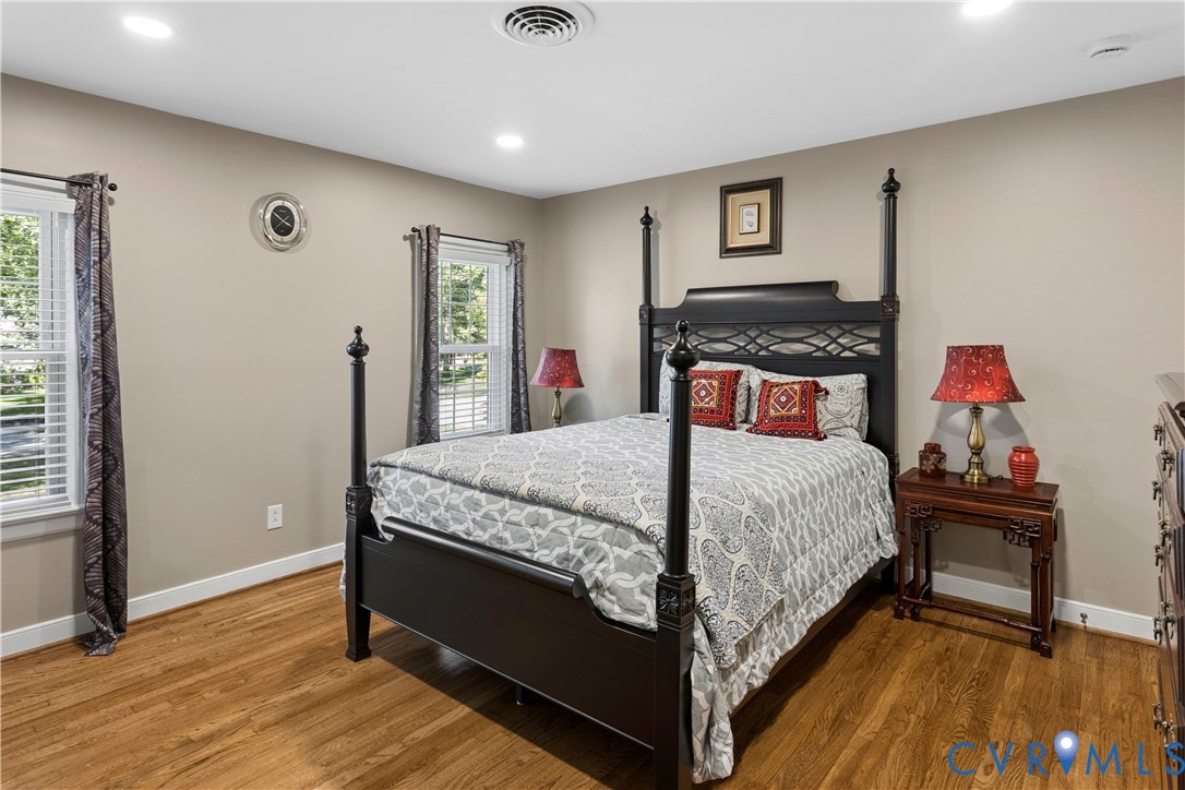 Neutral wall tones, wood-finish flooring, and recessed ceiling lighting
