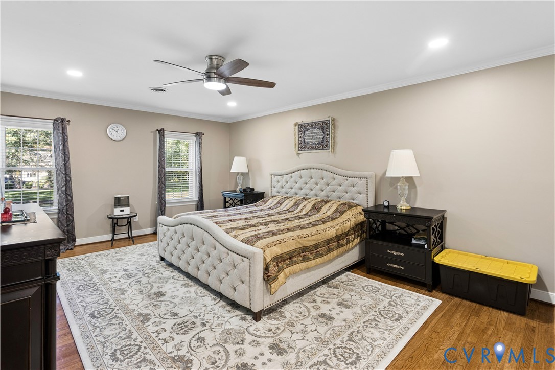 Neutral-toned walls, recessed lighting, wood-finish flooring, and a ceiling fan with integrated light fixture