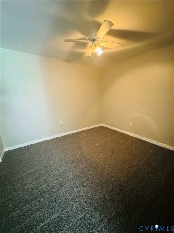 Neutral wall finish, gray wall-to-wall carpeting and a ceiling fan