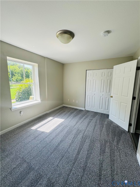 Room featuring neutral wall tones and gray carpeting
