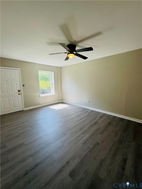 Neutral-toned interior featuring laminate flooring and a ceiling fan