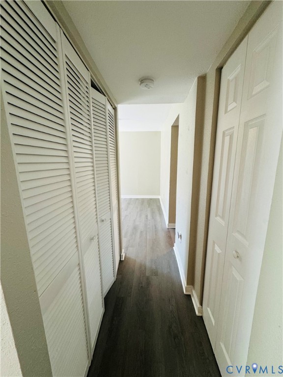 Hallway featuring laminate flooring